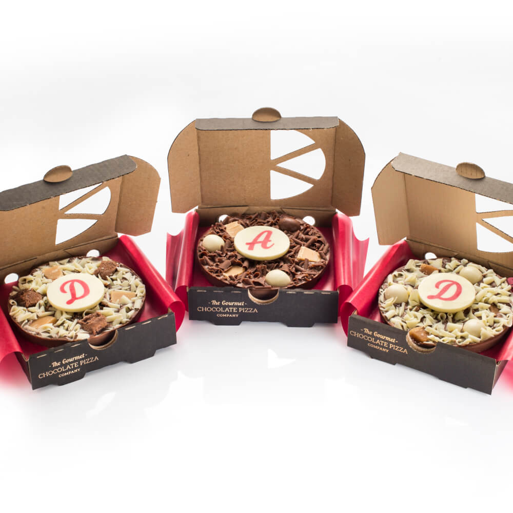 Our Dad Mini Chocolate Pizza Gift Set includes 3 x 4" Mini Chocolate Pizzas, each with a personalised letter plaque spelling out the word DAD.